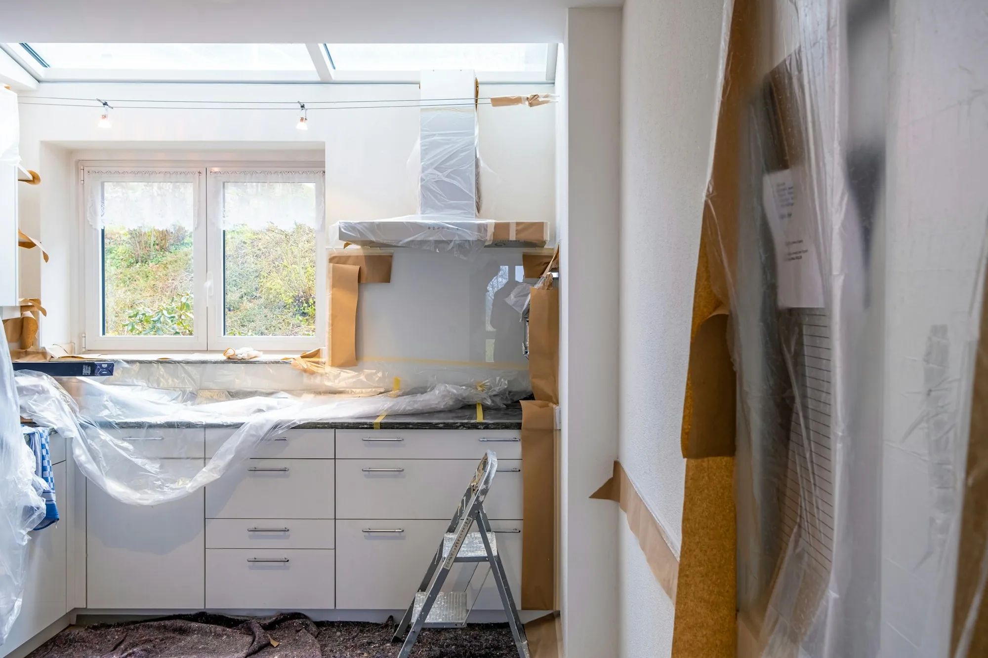 Kitchen covered in plastic sheeting during a renovation